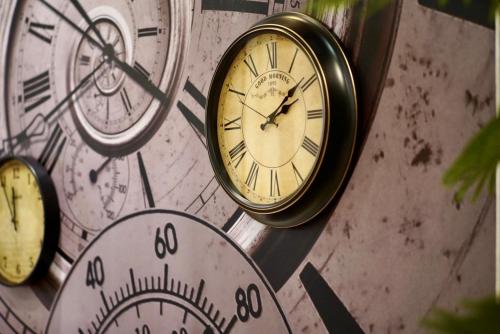a group of clocks on a wall at Finders Hotel Hualien Wen Hua in Hualien City