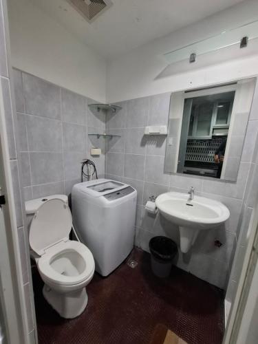 a bathroom with a toilet and a sink at King of kings at SEA RESIDENCES in Manila