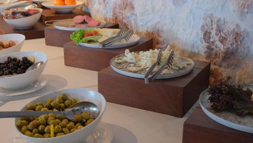 a table with plates of food and bowls of food at Hotel Delta in Fethiye