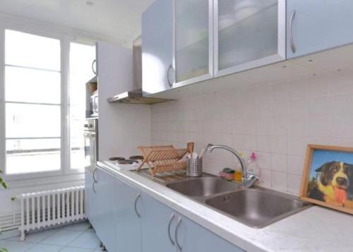 a kitchen with a sink and a counter top at Chambre chez l'habitant dans un appartement à 2 pas de la gare SNCF et à 300m de la gare routière in Creil