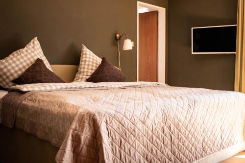 a bedroom with a bed with a white comforter at Zur Hilter Mühle in Lathen