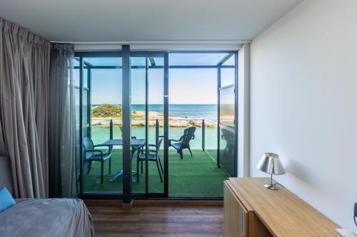 a bedroom with a bed and a view of the ocean at Hotel Astuy in Isla