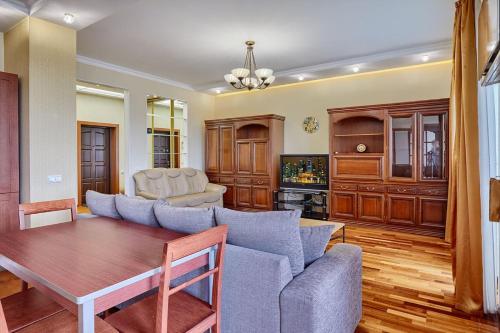 a living room with a couch and a table at Botanic Towers the house has a shelter in Kyiv