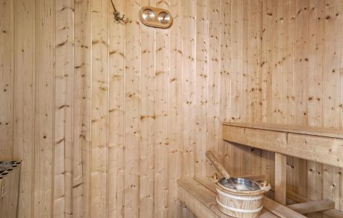 a wooden room with a bucket on a wooden wall at Stunning Home In Børkop With Sauna in Børkop