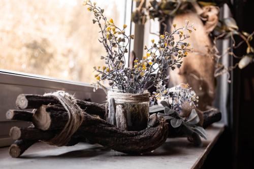 a vase filled with flowers sitting on a window sill at Zur Hilter Mühle in Lathen