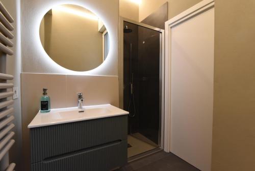 a bathroom with a sink and a mirror at Rooms de' Carracci in Bologna