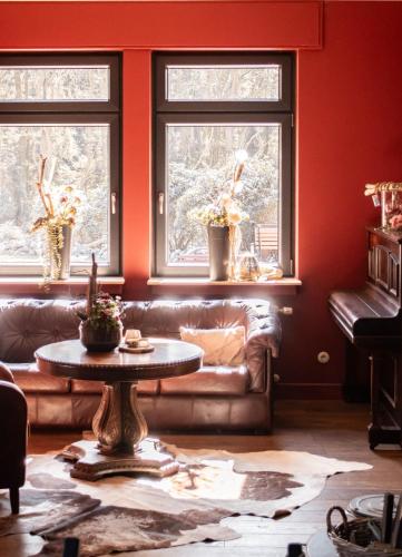 a living room with a couch and two windows at Zur Hilter Mühle in Lathen