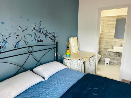 a blue bedroom with a bed and a sink at Da Mauro & Michela 2 - XL Apartment - Metro C in Borghesiana 