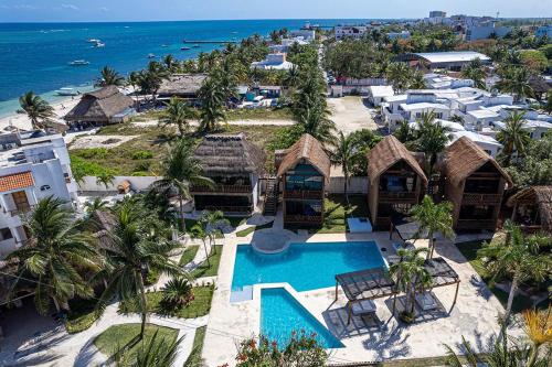 an aerial view of a resort with a swimming pool at Kabañas & Beach Club Ojo de Agua in Puerto Morelos