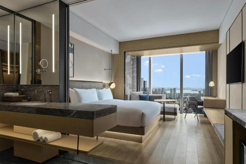 a hotel room with a bed and a bathroom at AC Hotel Suzhou Industrial Park in Suzhou