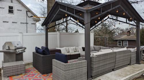 a pergola with couches and a grill in a backyard at Sunny & Spacious 2BD 1BA WFH Apt-Huge Yard & Patio in Fairfield