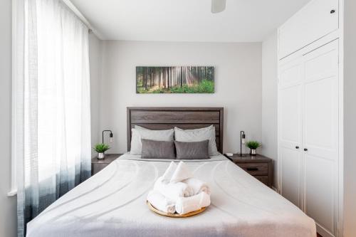 a bedroom with a bed with a towel on it at Sunny & Spacious 2BD 1BA WFH Apt-Huge Yard & Patio in Fairfield