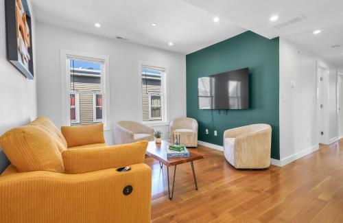 a living room with a couch and a tv at 3BR2Bth TD Garden,MIT,Harvard,BOS,2 Parking Spaces in Somerville