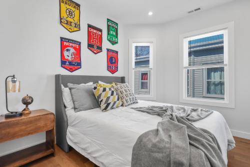 a bedroom with a bed with posters on the wall at 3BR2Bth TD Garden,MIT,Harvard,BOS,2 Parking Spaces in Somerville