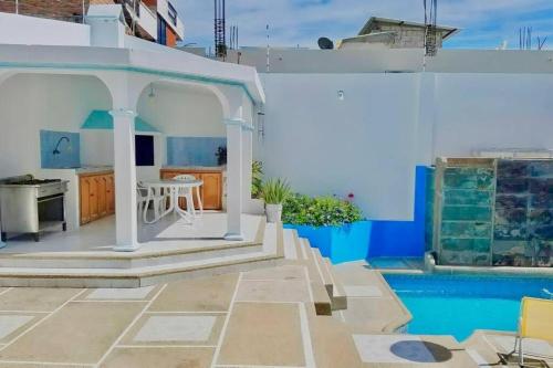 a villa with a swimming pool and a house at Casa Palmare in Manta