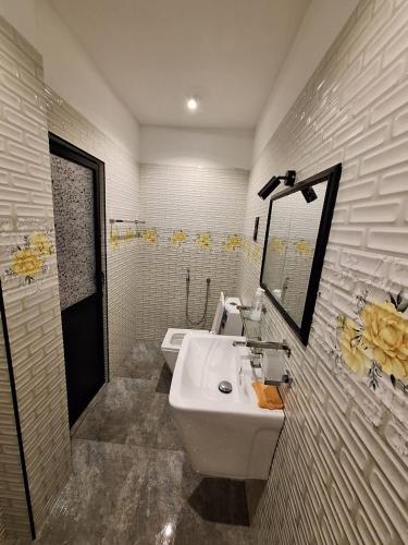 a bathroom with two sinks and a mirror at Adrian Dilneth in Weligama