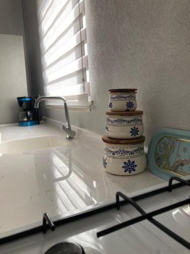 a kitchen counter with a stack of blue and white vases at Kabaklı Konaklama Turizm Amaçlı Kiralık Konut in Kabaklı
