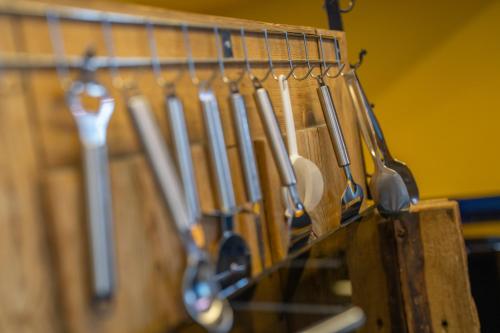 a bunch of knives hanging on a rack at Chalet Schtuba in Zermatt