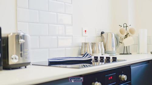 a kitchen counter top with a stove top oven at Old Silk Apartments - Luxury Studios, 1 & 2-beds in Coventry City Centre by COVSTAYS in Coventry