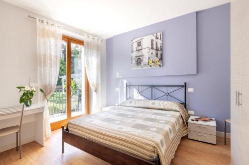 a bedroom with a bed and a window at Residenza Marano 2B in Cupra Marittima