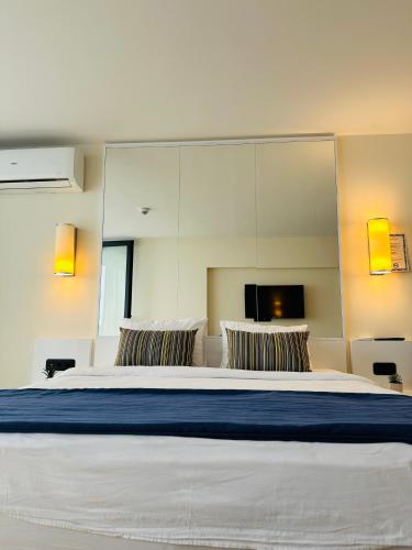 a bedroom with a large bed with a large mirror at Orbi City Luxury Apartment in Batumi