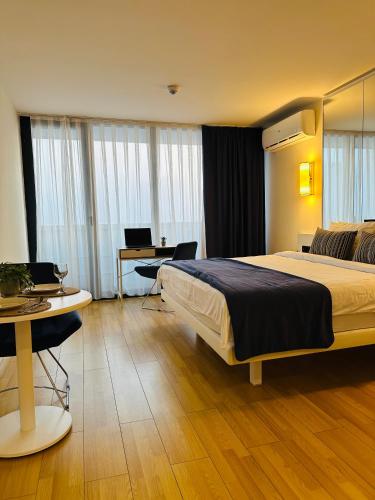 a hotel room with a bed and a desk at Orbi City Luxury Apartment in Batumi