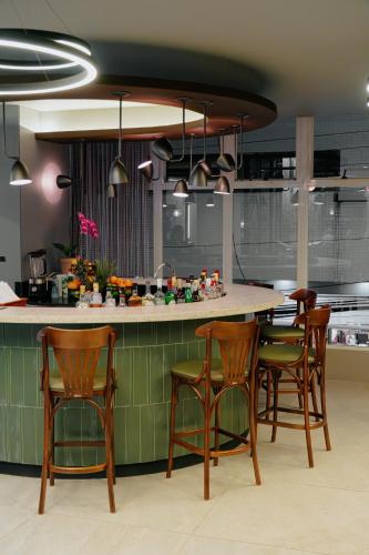 a kitchen with wooden chairs and a kitchen island at Hotel Plaza Camboriú in Balneário Camboriú
