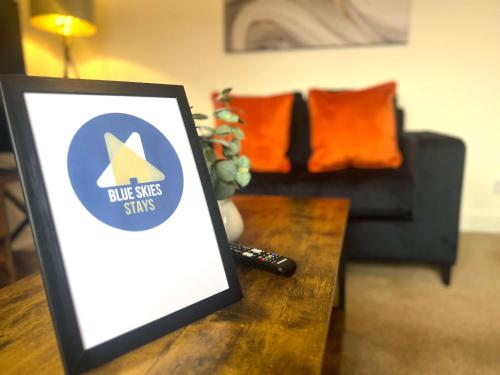 a table with a picture of a living room with a couch at The Billingham House By Blue Skies Stays in Stockton-on-Tees