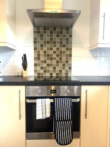 a kitchen with a stove with a towel on it at The Billingham House By Blue Skies Stays in Stockton-on-Tees