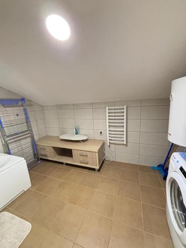 a laundry room with a sink and a washing machine at Aerodrom Appartment ''Ana'' in Tivat
