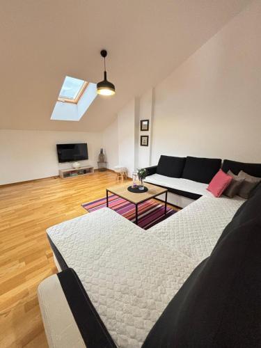 a living room with a couch and a table at Aerodrom Appartment ''Ana'' in Tivat
