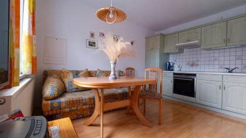 a living room with a table and a couch at Ferienhaus "Morgensonne" in Kurort Gohrisch