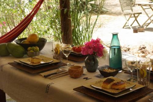 a table with plates of food and drinks on it at Bed and breakfast Keur Niaye in Toubakouta