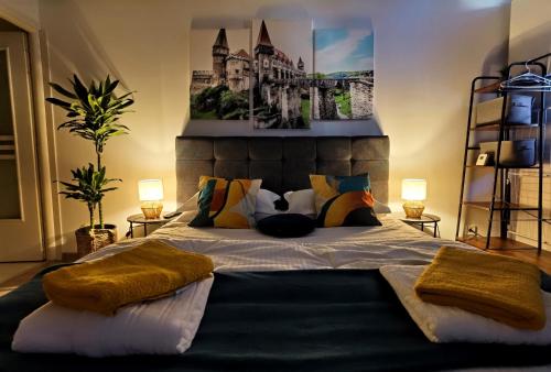 a bedroom with a large bed with pillows on it at Blue Shades Studio in Hunedoara