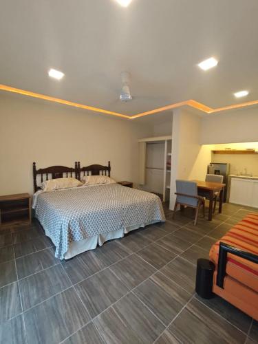 a bedroom with a bed and a table and a desk at Loft Dee Dee centrical location in Puerto Vallarta