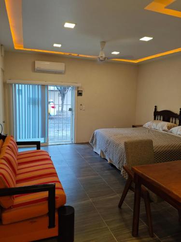 a room with two beds and a couch and a table at Loft Dee Dee centrical location in Puerto Vallarta