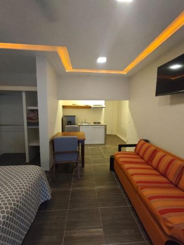 a room with a couch and a table and a kitchen at Loft Dee Dee centrical location in Puerto Vallarta