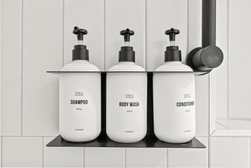 a group of three shampoo and soap bottles on a shelf at Kasa The Addison San Francisco in San Francisco