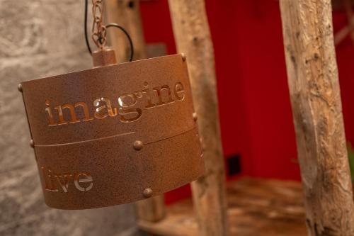 a key chain with the words imagine live on it at Schnapskeller in Zermatt