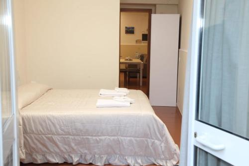 a bedroom with a bed with two towels on it at La Casetta per te in Gravina di Catania