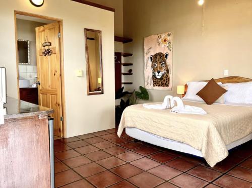 a bedroom with a bed with two towels on it at Mi Zaru sea view hotel Free MA park tour & breakfast in Manuel Antonio