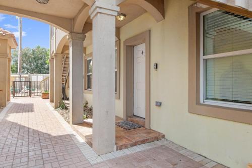 a house with a porch and a white door at Ground Floor Beach Side 2Min Walk To The Beach SF in South Padre Island
