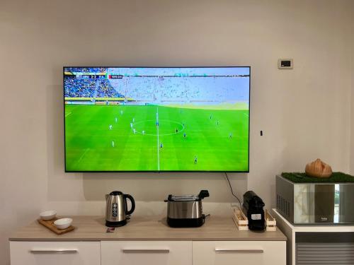 a large flat screen tv hanging on a wall at Ma Maison Hospital University School in Brescia
