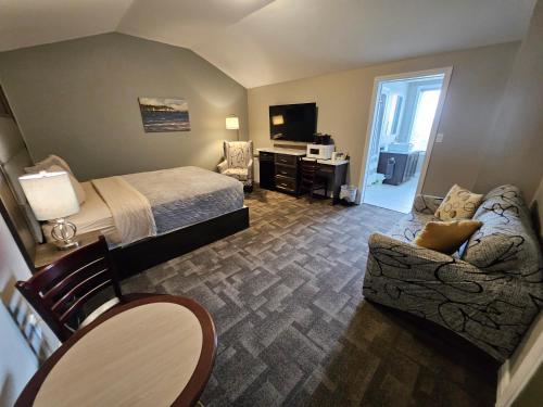 a hotel room with a bed and a couch at Newfound Inn & Suites in Topsail