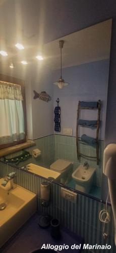 a bathroom with two sinks and a mirror at Alloggi Turistici con Piscina Palestra Jacuzzi Sauna - All Inclusive in Anzio