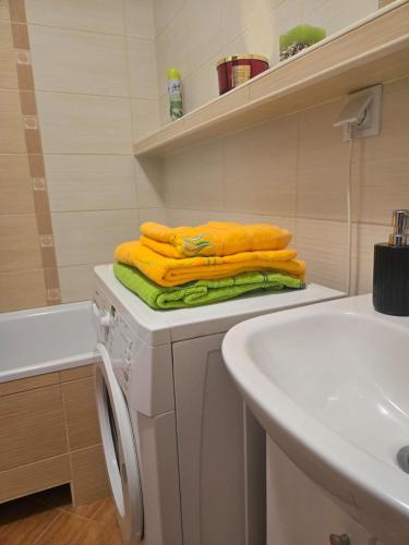 a bathroom with yellow towels on a counter next to a sink at Apartament Grabskiego in Gorzów Wielkopolski
