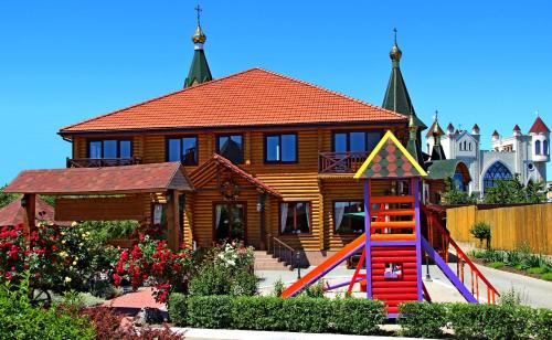 a house with a playground in front of a house at Комплекс відпочинку Пампушка & Подушка in Odesa