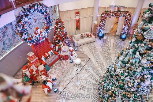 an overhead view of a living room with christmas trees at Marambaia Hotel e Convenções in Balneário Camboriú