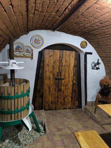 a room with a wooden door and a barrel at Sklep Vendelín in Mikulčice
