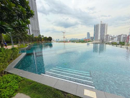 a large swimming pool in the middle of a city at M Vertica Cheras by RASBO Galaxy Suites in Kuala Lumpur